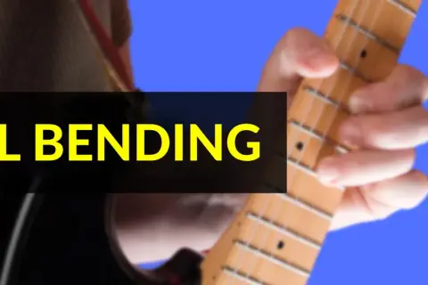 Mano che preme le corde di una chitarra elettrica, mostrando la tecnica del bending.