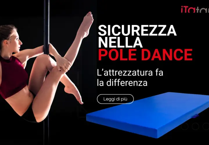Donna esegue una figura di **danza al palo** con un tappetone blu per sicurezza.