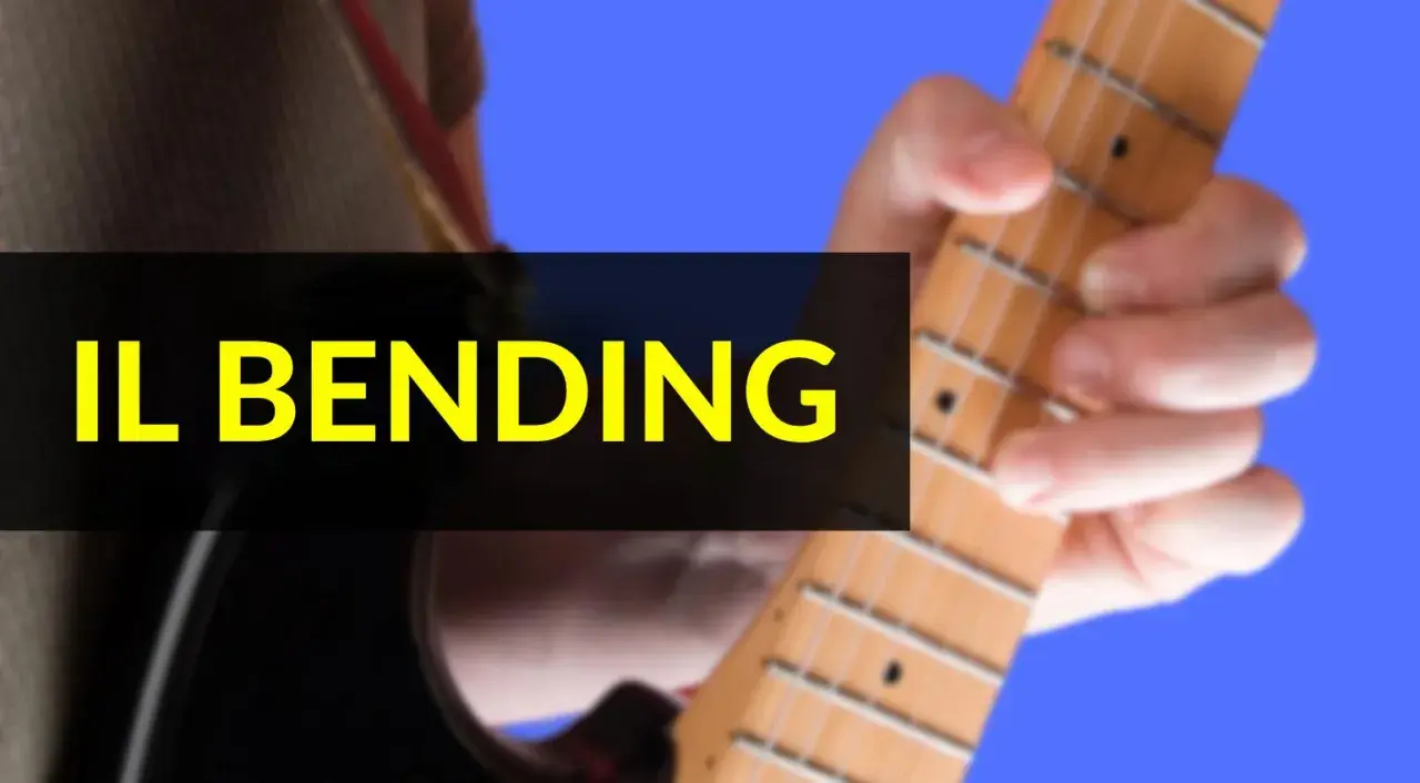 Mano che preme le corde di una chitarra elettrica, mostrando la tecnica del bending.